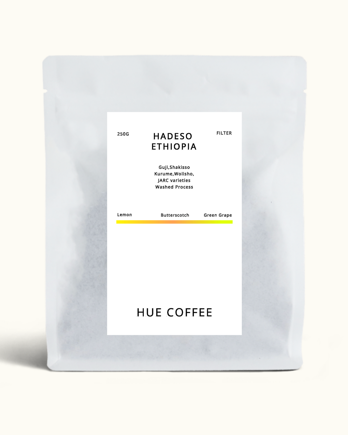 A matte silver coffee bag with a white label reading 'HADESO ETHIOPIA' and 'HUE COFFEE' on a light cream background.