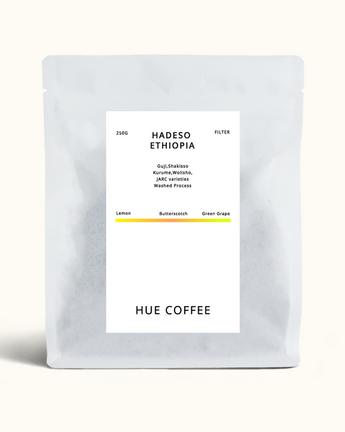 A matte silver coffee bag with a white label reading 'HADESO ETHIOPIA' and 'HUE COFFEE' on a light cream background.