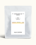A matte white coffee pouch with a centered white label reading 'KIANGUNDO AB KENYA' and 'HUE COFFEE', photographed on a clean off-white background.