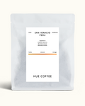 A matte white coffee bag with a minimalist white label reading 'SAN IGNACIO PERU' and 'HUE COFFEE', photographed on a clean off-white background.